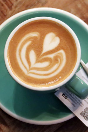 A cup of coffee with latte art on top.